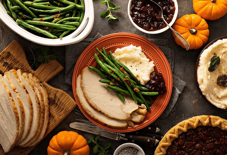 Thanksgiving entrées displayed on dining table. 